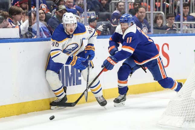 Mar 25, 2023; Elmont, New York, USA;  Buffalo Sabres defenseman Ilya Lyubushkin (46) and New York Islanders left wing Zach Parise (11) battle for control of the puck in the second period at UBS Arena.