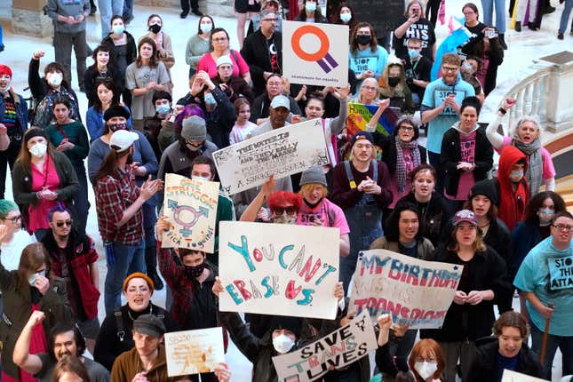 Trans-rights activists protest outside the House chamber at the state Capitol before the State of the State address Monday, Feb. 6, 2023, in Oklahoma City.