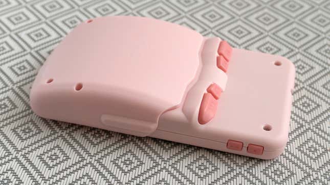 The GDK Mini Plus handheld with the dock accessory attached, showing the added bulge on the back of the device.