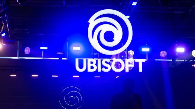 A person stands in front of a Ubisoft booth.