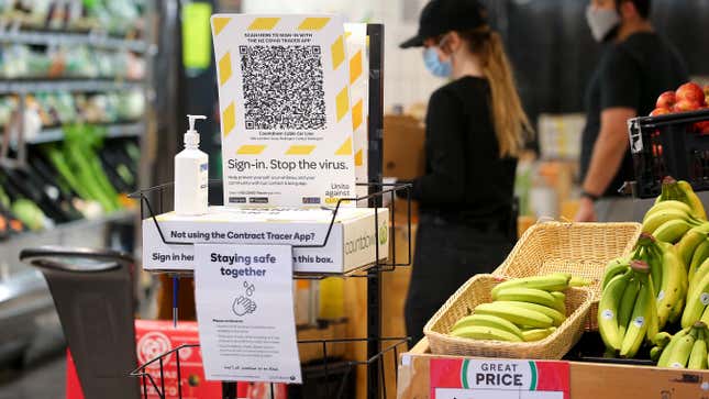 A New Zealand Covid Tracer App QR code and hand sanitizer sit at the entrance to a supermarket during the first day of a national lockdown on August 18, 2021 in Wellington, New Zealand.