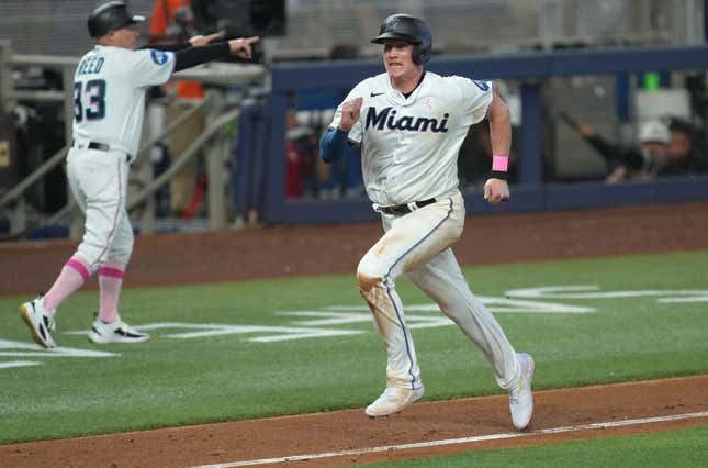May 14, 2023; Miami, Florida, USA;  Miami Marlins first baseman Garrett Cooper (26) scores a run in the seventh inning against the Cincinnati Reds at loanDepot Park.