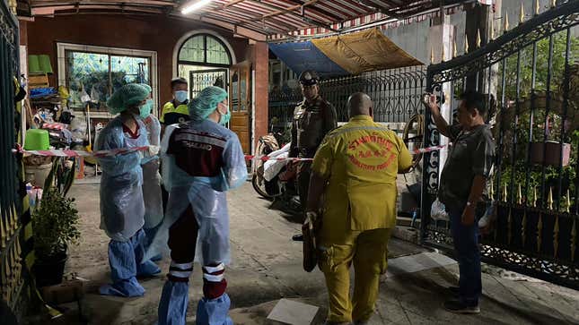 Forensic officers and a rescue worker arrive at a house where a woman and her two sons were killed and her husband was found severely injured, in Samut Prakan province on Aug. 28, 2023. At least 11 people are suspected to be involved with a loan scam that allegedly drove a man to kill his wife and two young boys before trying to take his own life in their family home, Thai police said Wednesday. (AP Photo/Pongsakorn Rodphai)