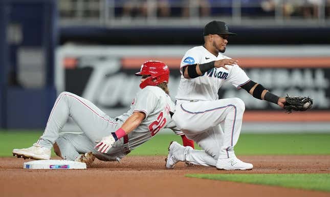 Jul 31, 2023; Miami, Florida, USA; Philadelphia Phillies first baseman Alec Bohm (28) steals second base as Miami Marlins second baseman Luis Arraez (3) gathers the ball in the first inning at loanDepot Park.