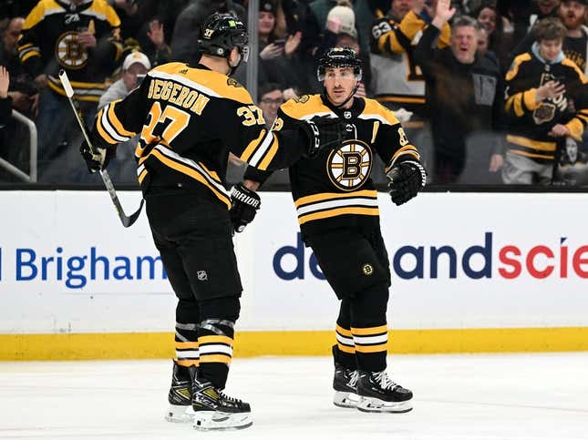Mar 9, 2023; Boston, Massachusetts, USA; Boston Bruins left wing Brad Marchand (63) celebrates with center Patrice Bergeron (37) after scoring a goal against the Edmonton Oilers during the first period at the TD Garden.