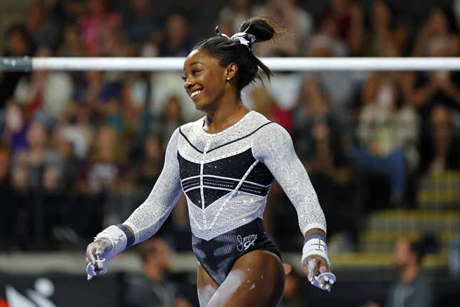  Simone Biles competes in the uneven bars during the Core Hydration Classic at Now Arena on August 05, 2023 in Hoffman Estates, Illinois.