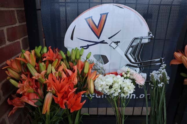 Flowers are placed at a memorial for the slain University of Virginia football players.
