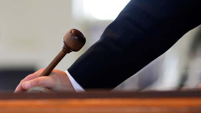 An auctioneer holds his gavel 