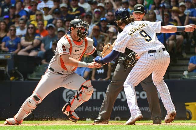May 28, 2023; Milwaukee, Wisconsin, USA; San Francisco Giants catcher Blake Sabol (2) tags out Milwaukee Brewers third baseman Brian Anderson (9) in the first inning at American Family Field.