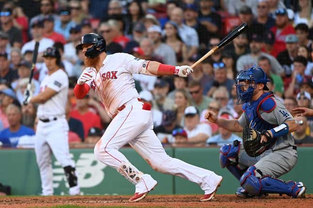 Aug 26, 2023; Boston, Massachusetts, USA;  Boston Red Sox first baseman Justin Turner (2) hits an RBI single against the Los Angeles Dodgers during the seventh inning at Fenway Park.