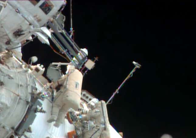 In this image made from video provided by NASA, Russian cosmonauts Pavel Vinogradov, left, and Roman Romanenko perform a spacewalk outside the International Space Station to gather old science experiments and install new ones, and replace a navigation device.