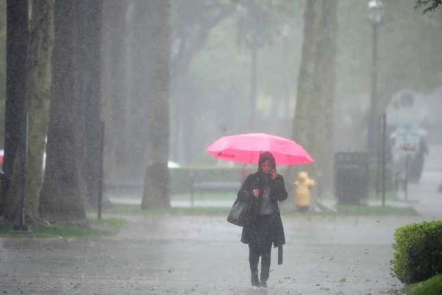Rain falls on a pedestrian on the University of Southern California campus on Tuesday, March 21, 2023, in Los Angeles.