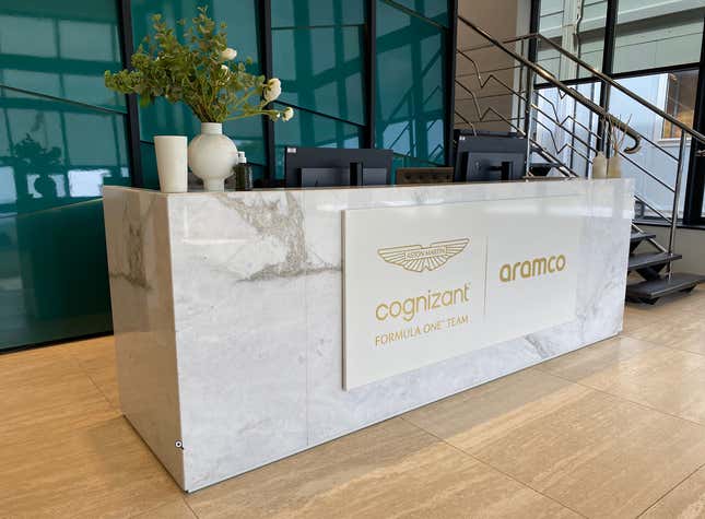 A marble reception desk adorned with an Aston Martin F1 sign