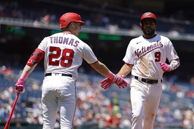 May 14, 2023; Washington, District of Columbia, USA;Washington Nationals third baseman Jeimer Candelario (9) celebrates with Nationals right fielder Lane Thomas (28) after scoring a run on an RBI single by Nationals shortstop CJ Abrams (not pictured) against the New York Mets during the fourth inning of the continuation of a suspended game at Nationals Park.