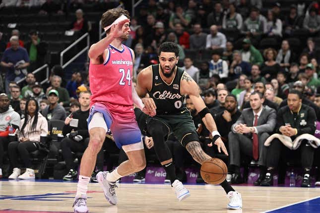 Mar 28, 2023; Washington, District of Columbia, USA; Boston Celtics forward Jayson Tatum (0) dribbles as Washington Wizards forward Corey Kispert (24) defends during the first half at Capital One Arena.