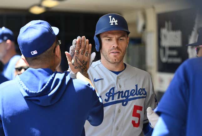 May 10, 2023; Milwaukee, Wisconsin, USA; Los Angeles Dodgers first baseman Freddie Freeman (5) is congratulated in the dug out after hitting a home run against the Milwaukee Brewers in the fourth inning at American Family Field.