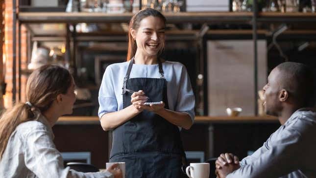 waitress laughing at table with customers