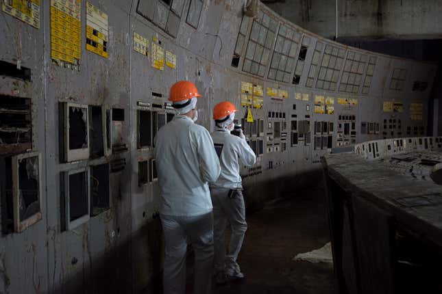 Scientists walking in the control room at Chernobyl's Reactor 3.