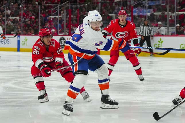 Apr 19, 2023; Raleigh, North Carolina, USA; New York Islanders center Jean-Gabriel Pageau (44) takes a shot against Carolina Hurricanes left wing Teuvo Teravainen (86) during the second period in game two of the first round of the 2023 Stanley Cup Playoffs at PNC Arena.
