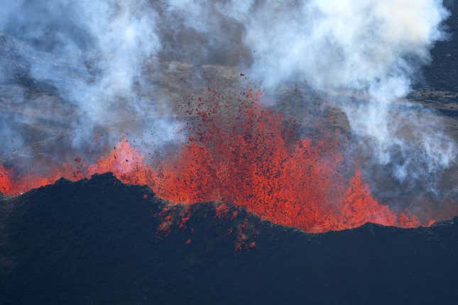 Lava shoots up from a fissure of Mauna Loa Volcano as it erupts on December 05, 2022 in Hilo, Hawaii.