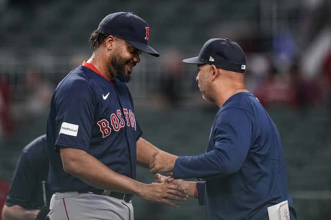 May 10, 2023; Cumberland, Georgia, USA; Boston Red Sox relief pitcher Kenley Jansen (74) reacts with manager Alex Cora (13) after recording his 400th career save against the Atlanta Braves at Truist Park.