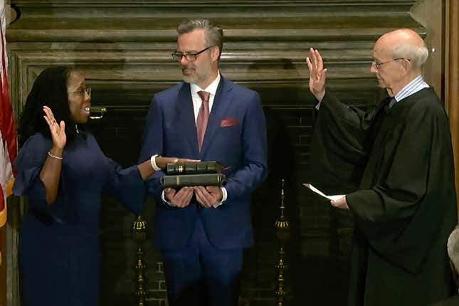 In this image from video provided by the Supreme Court, retired Supreme Court Associate Justice Stephen Breyer administers the Judicial Oath to Ketanji Brown Jackson as her husband Patrick Jackson holds the Bible at the Supreme Court in Washington, Thursday, June 30, 2022.