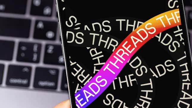 Threads mobile logo app on a screen smartphone iPhone closeup.