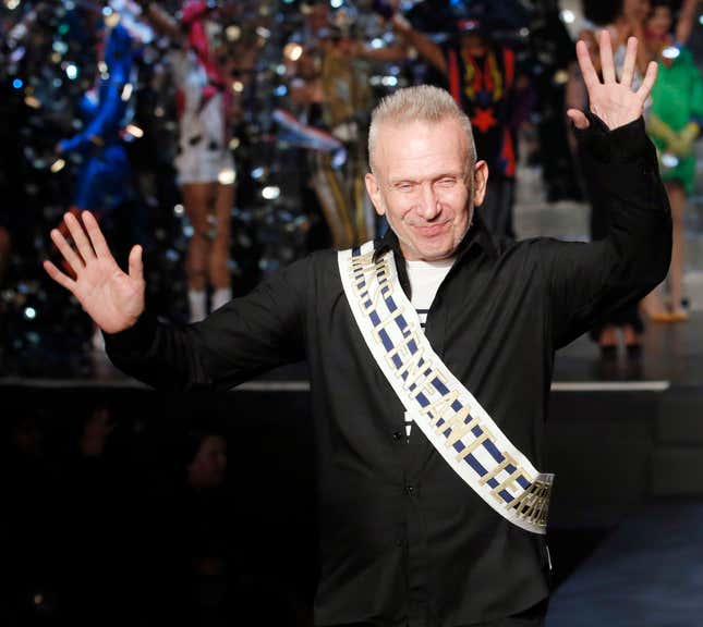 French designer Jean Paul Gaultier reacts as he appears at the end of his Spring/Summer 2015 women's ready-to-wear collection during Paris Fashion Week September 27, 2014. Gaultier, the theatrical star designer of the French fashion world, presented his last women's ready-to-wear show today. The brand, owned by Spanish perfumer Puig, announced earlier this month that it will from now on focus its efforts on haute couture, perfume, and industry collaborations. REUTERS/Gonzalo Fuentes (FRANCE - Tags: FASHION PROFILE ENTERTAINMENT SOCIETY TPX IMAGES OF THE DAY) - RTR47YU3