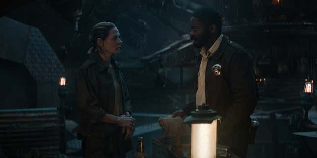 Rebecca Ferguson and David Oyelowo look pensively at each other in an underground silo.