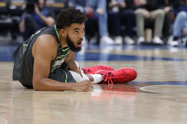 Nov 28, 2022; Washington, District of Columbia, USA; Minnesota Timberwolves center Karl-Anthony Towns (32) holds his leg after being injured against the Washington Wizards in the third quarter at Capital One Arena.