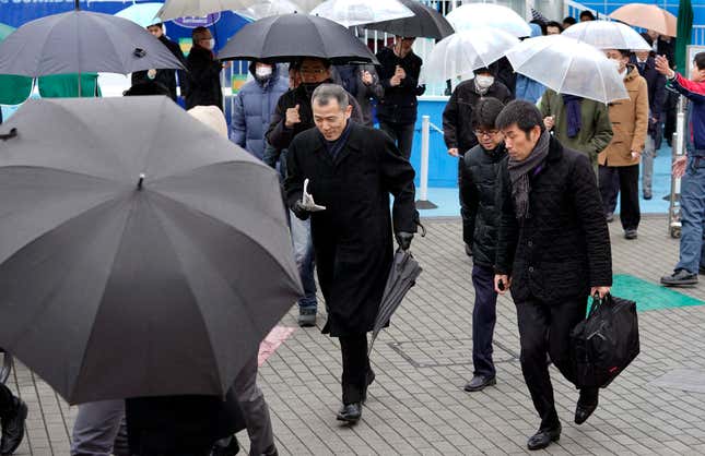 Participants take refuge during an evacuation drill simulating a North Korea ballistic missile attack in Tokyo.