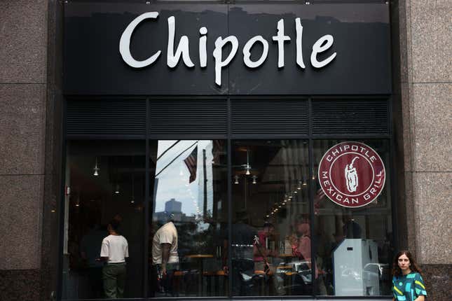 Chipotle store signage is seen on August 10, 2022, in New York City. NYC Mayor Eric Adams announced on Tuesday that Chipotle Mexican Grill announced that they would be paying $20 million dollars to current and former workers in their NYC restaurants for violating city labor laws