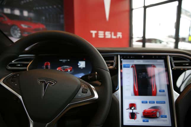 The inside of a Tesla vehicle is viewed as it sits parked in a new Tesla showroom.