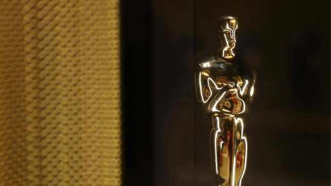 A golden Academy Award has been placed near a golden curtain.