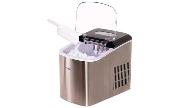 A portable ice maker filled with ice cubes about to be collected with a plastic scoop.