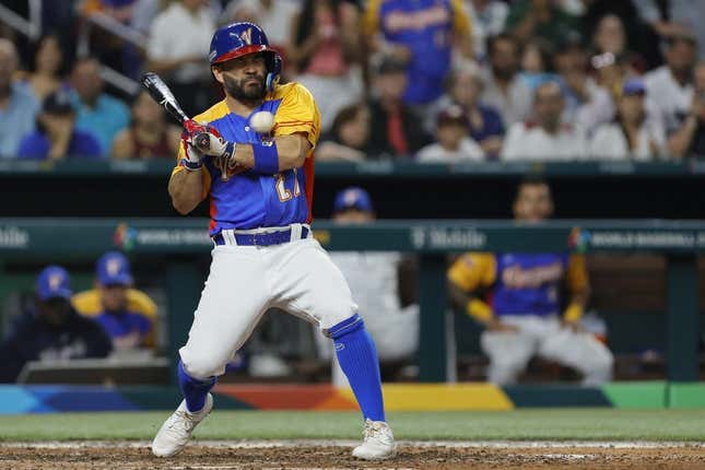 Mar 18, 2023; Miami, Florida, USA; Venezuela second baseman Jose Altuve (27) gets hit by a pitch during the fifth inning against the USA at LoanDepot Park.