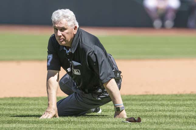 Apr 12, 2023; Cleveland, Ohio, USA; Umpire Larry Vanover (27) gets up after being hit with the baseball during a play in the fifth inning of the game between the Cleveland Guardians and the New York Yankees at Progressive Field.