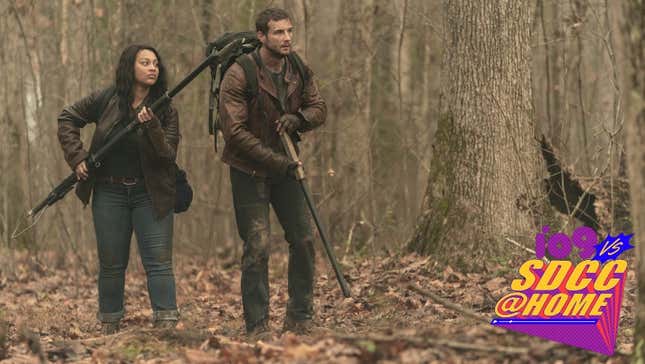 The Walking Dead: World Beyond's Aliyah Royale and Nico Tortorella stay ready in a forest with weapons in hand.
