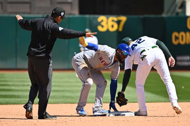 Apr 15, 2023; Oakland, California, USA; New York Mets right fielder Starling Marte (6) calls for time and umpire Gabe Morales (47) makes the call of safe during the sixth inning at RingCentral Coliseum.