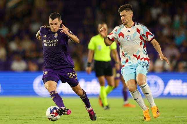 Jul 1, 2023; Orlando, Florida, USA;  Orlando City SC defender Kyle Smith (24) controls the ball from Chicago Fire FC midfielder Gaston Gimenez (30) in the second half at Exploria Stadium.