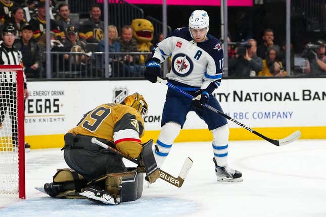 Apr 18, 2023; Las Vegas, Nevada, USA; Vegas Golden Knights goaltender Laurent Brossoit (39) makes a save as Winnipeg Jets center Adam Lowry (17) looks for the rebound during the first period of game one of the first round of the 2023 Stanley Cup Playoffs at T-Mobile Arena.