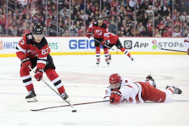 Mar 12, 2023; Newark, New Jersey, USA; New Jersey Devils left wing Jesper Bratt (63) skates with the puck as Carolina Hurricanes defenseman Brent Burns (8) defends during the second period at Prudential Center.