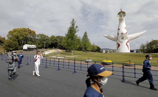 Former Japanese swimmer Aya Terakawa carries the Tokyo 2020 Olympic torch during the torch relay at the Expo ‘70 Commemorative Park in Suita, after it was barred from public roads across Osaka region due to a spike in coronavirus (COVID-19) cases.