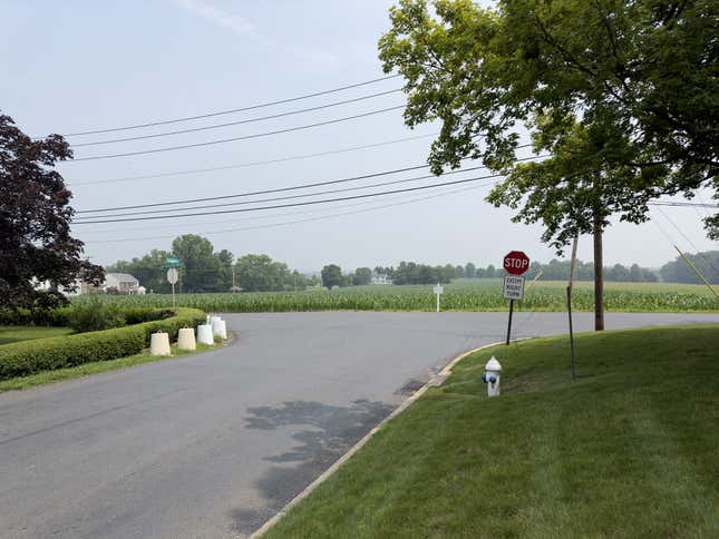 Photo of an intersection containing a "Stop" sign with an "Except Right Turn" sign posted underneath it.