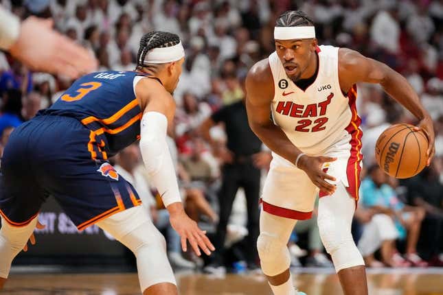 May 6, 2023; Miami, Florida, USA; Miami Heat forward Jimmy Butler (22) looks to dribble the ball as New York Knicks guard Miles McBride (2) defends during the second half of game three of the 2023 NBA playoffs at Kaseya Center.