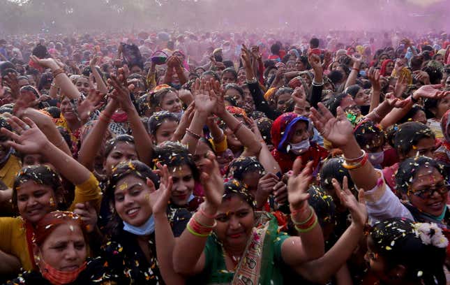 Devotees are showered with flower petals during the Holi celebrations in Mathura.