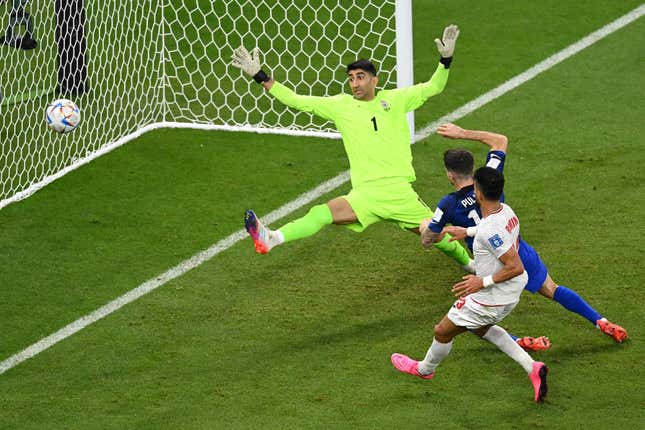 Christian Pulisic scores goal that sends U.S. into knockout round, before crashing into Iran’s goalie.