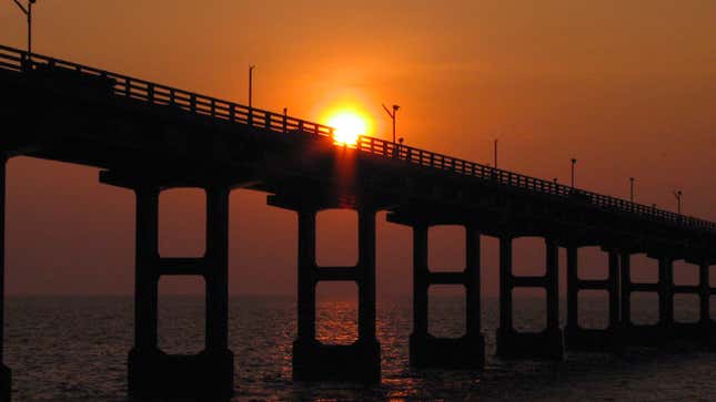 A photo of a bridge at sunset. 