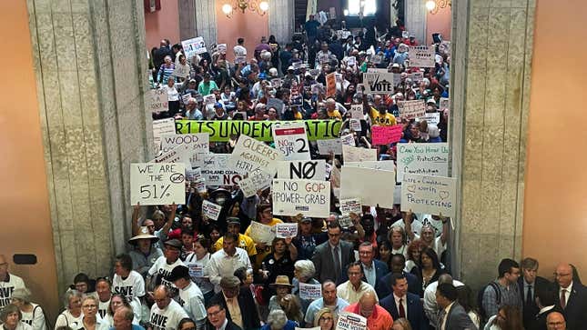 Supporters and opponents of a GOP-backed measure that would make it harder to amend the Ohio constitution packed the statehouse rotunda Wednesday, May 10, 2023, in Columbus, Ohio.