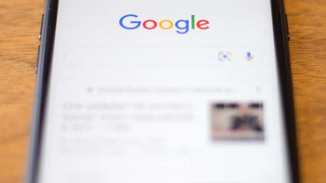A photo of a phone with Google Search open.